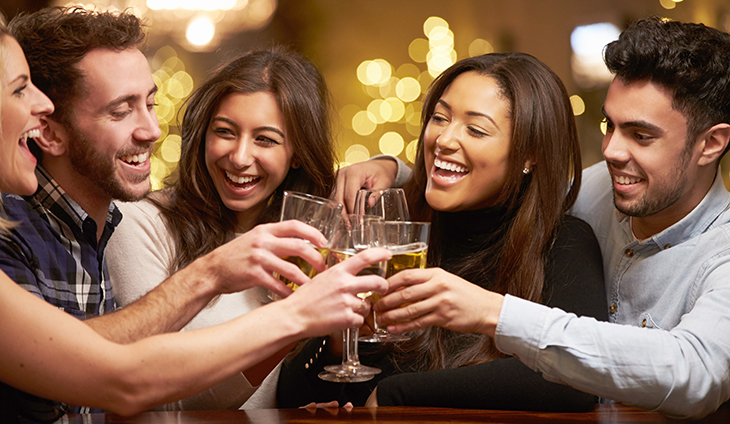 people smiling and clinking glasses