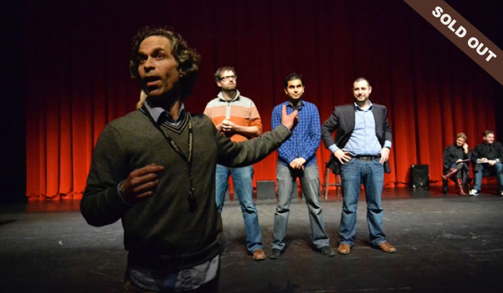 People standing on a theatre stage.