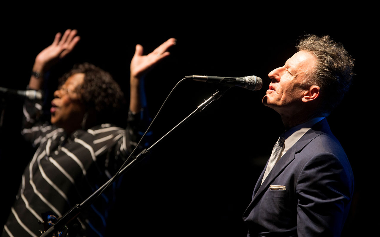 Lyle Lovett singing into a microphone