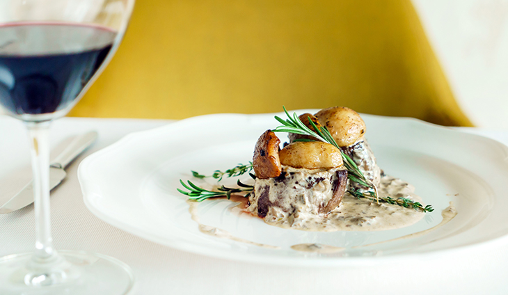 Plate of food with glass of red wine