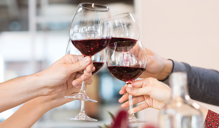 Clinking wine glasses.